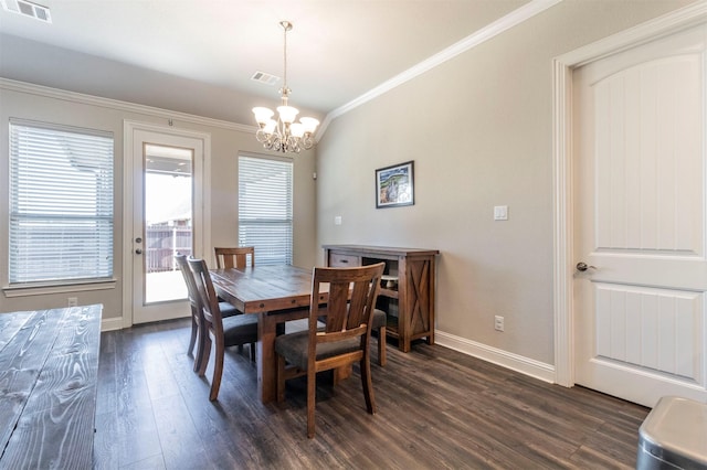 dining room featuring ornamental molding, dark hardwood / wood-style floors, and a notable chandelier