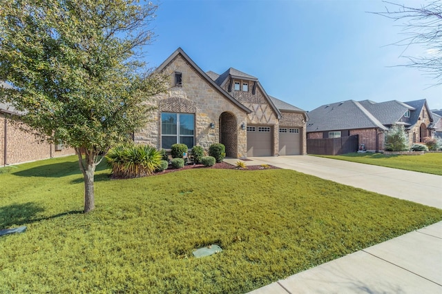 view of front of property with a garage and a front lawn