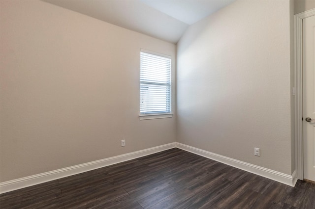 unfurnished room with dark hardwood / wood-style flooring and lofted ceiling