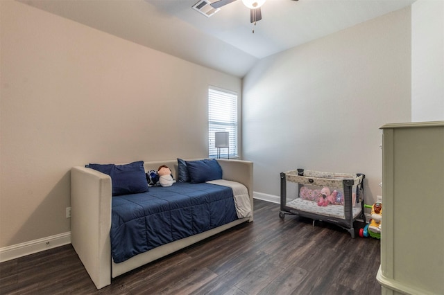 bedroom featuring vaulted ceiling, dark wood-type flooring, and ceiling fan