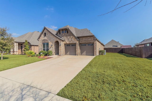 view of front of home with a garage and a front lawn