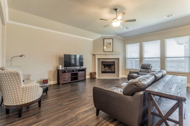 living room with dark hardwood / wood-style floors, a fireplace, lofted ceiling, ceiling fan, and crown molding