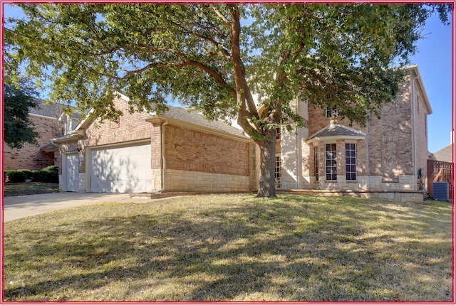 view of front facade with a garage, a front yard, and central air condition unit