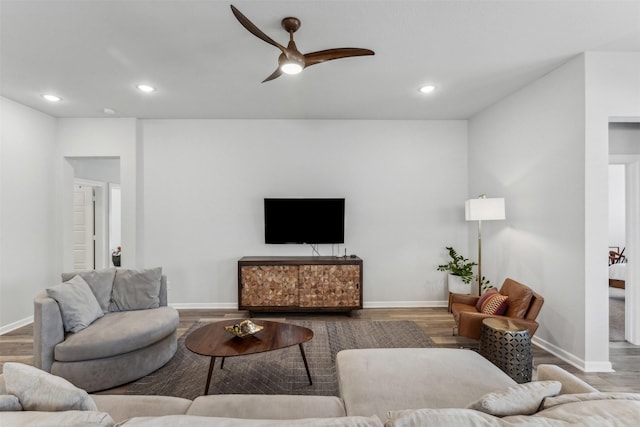 living room featuring hardwood / wood-style flooring and ceiling fan