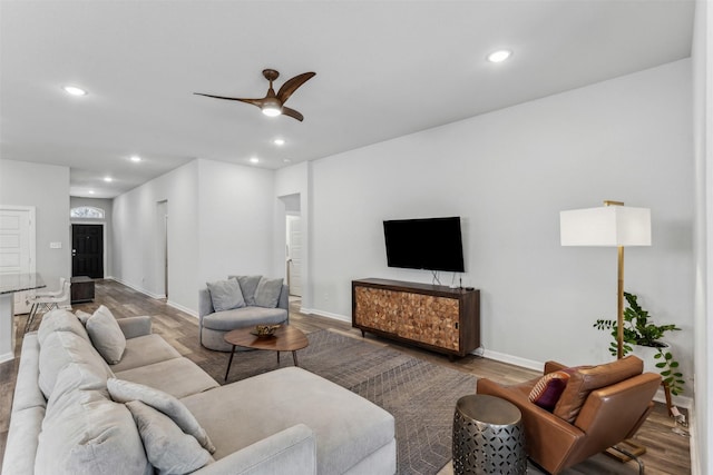 living room featuring light hardwood / wood-style flooring and ceiling fan