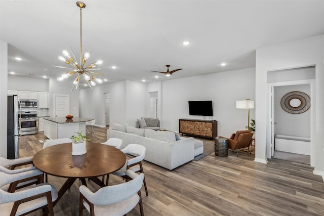 dining area with an inviting chandelier and light hardwood / wood-style floors