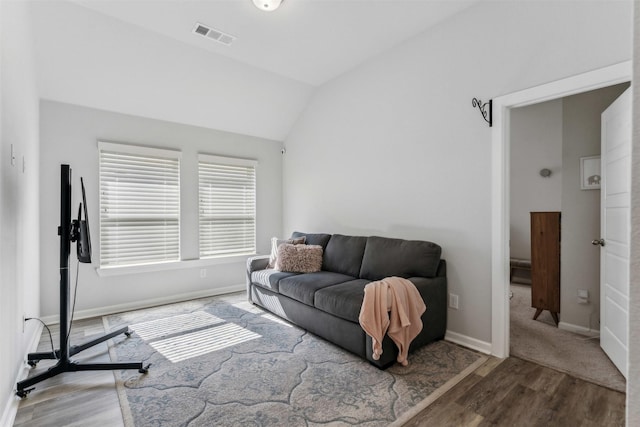 living room with hardwood / wood-style flooring and lofted ceiling