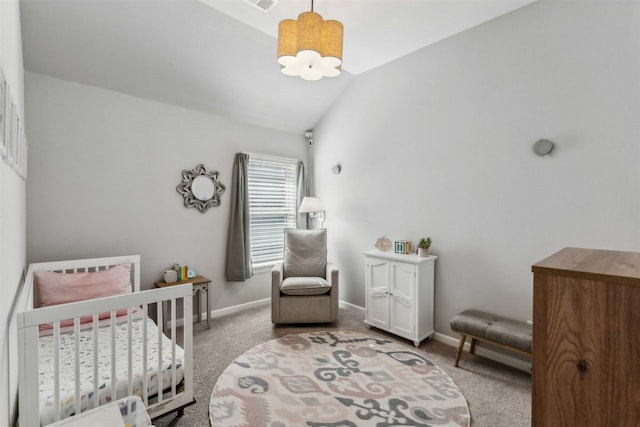 carpeted bedroom featuring a crib, lofted ceiling, and an inviting chandelier