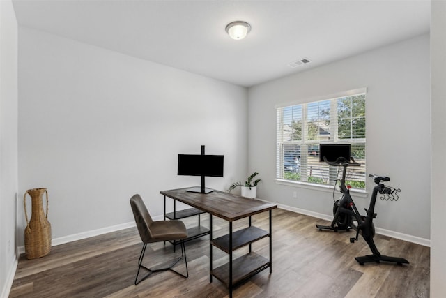 home office with hardwood / wood-style flooring