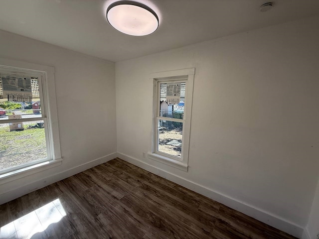 8112 Melrose St E, White Settlement, TX 76108 - empty room with dark wood-style flooring and a smoke detector