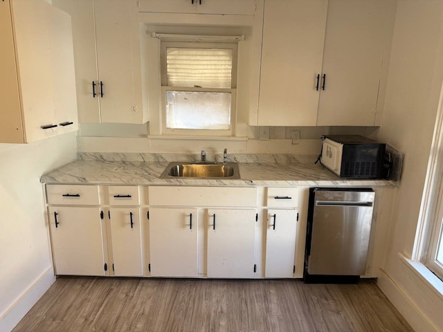 8112 Melrose St E, White Settlement, TX 76108 - kitchen with dishwasher, black microwave, light wood-type flooring, and light countertops