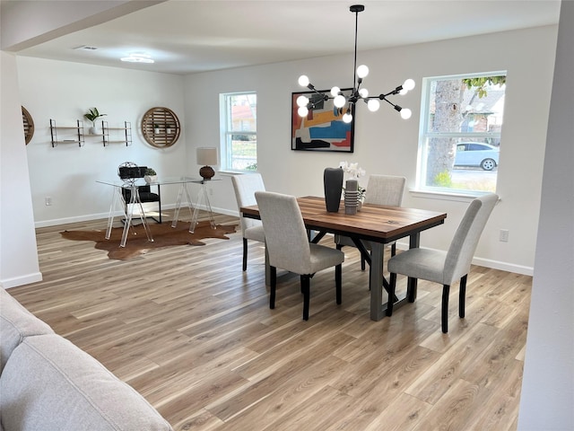 dining area featuring hardwood / wood-style floors and a chandelier