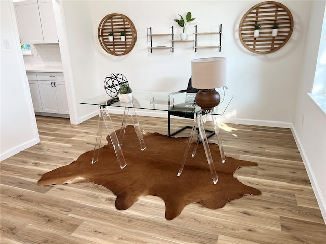 office with light hardwood / wood-style flooring