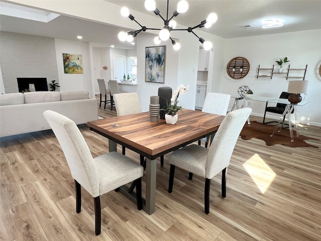 dining area with a chandelier and light wood-type flooring