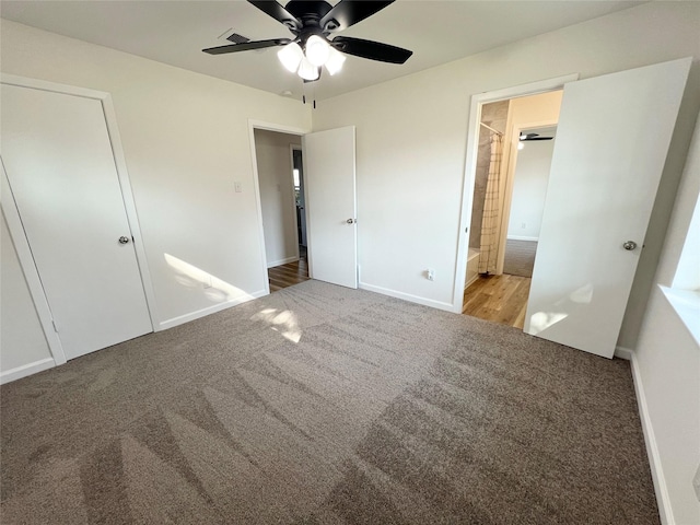 unfurnished bedroom with connected bathroom, carpet floors, and ceiling fan