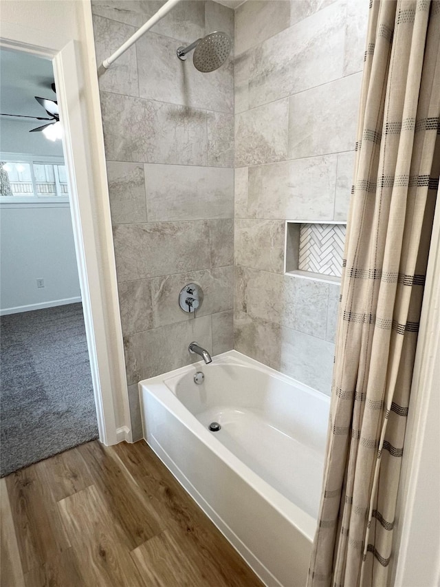 bathroom featuring wood-type flooring, shower / tub combo, and ceiling fan