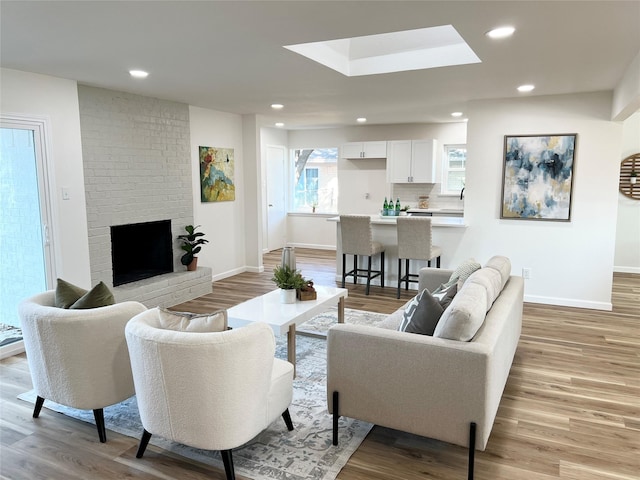 living room with a fireplace and light hardwood / wood-style flooring