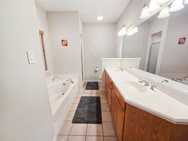 full bathroom featuring toilet, vanity, plus walk in shower, and tile patterned flooring