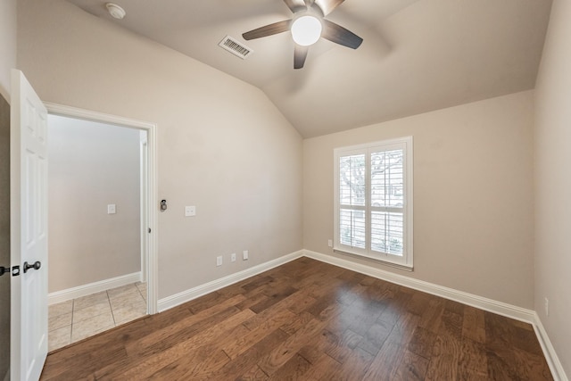 spare room with lofted ceiling, hardwood / wood-style floors, and ceiling fan