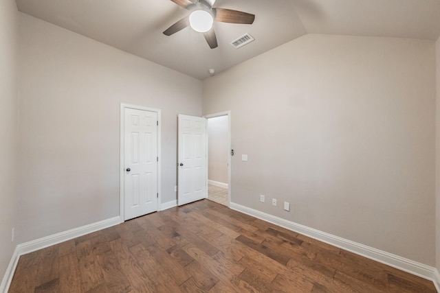 spare room with lofted ceiling, dark hardwood / wood-style floors, and ceiling fan