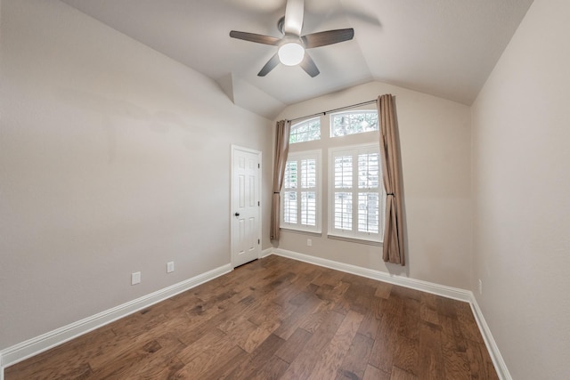 empty room featuring ceiling fan, lofted ceiling, and dark hardwood / wood-style flooring