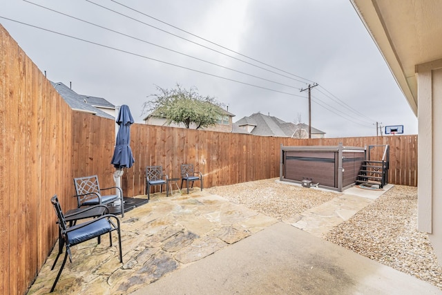 view of patio / terrace with a hot tub