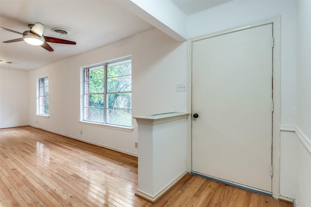 entrance foyer with ceiling fan and light hardwood / wood-style flooring