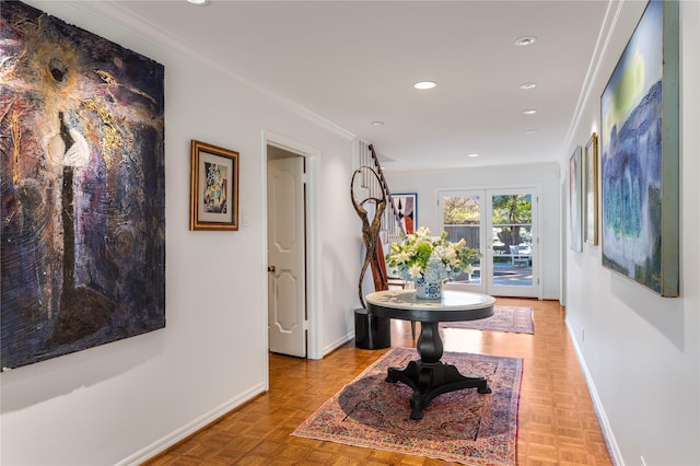 hall with crown molding and light parquet floors