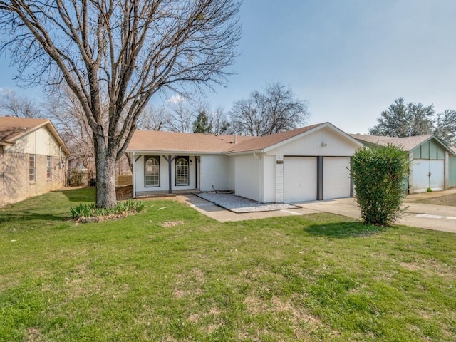 ranch-style home featuring a garage and a front lawn