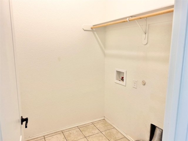 laundry area with hookup for a washing machine and light tile patterned flooring