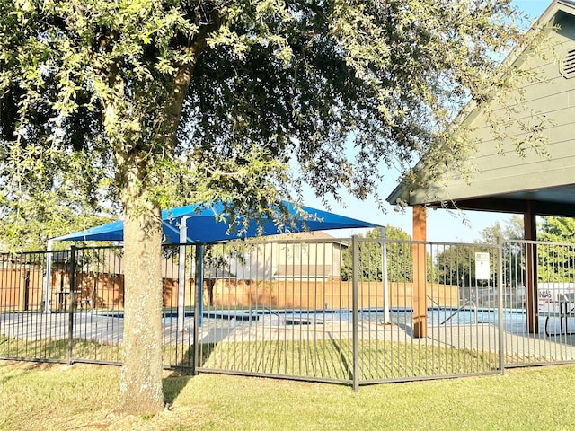 view of swimming pool with a lawn