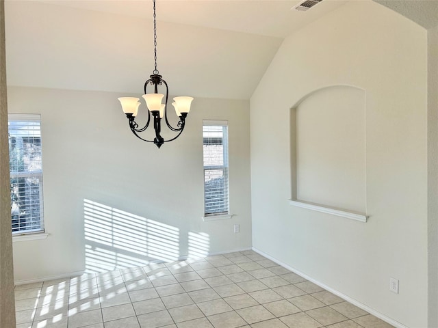 unfurnished room with an inviting chandelier, vaulted ceiling, and light tile patterned floors