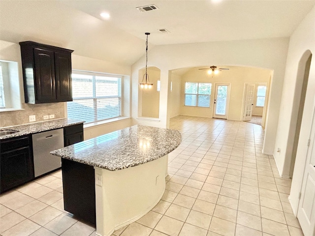 kitchen with lofted ceiling, light tile patterned floors, dishwasher, hanging light fixtures, and a center island