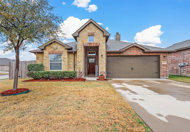 view of front of home with a garage and a front yard