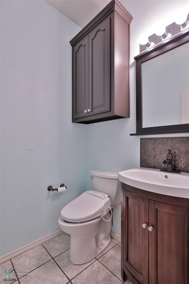 bathroom with vanity, tile patterned floors, and toilet