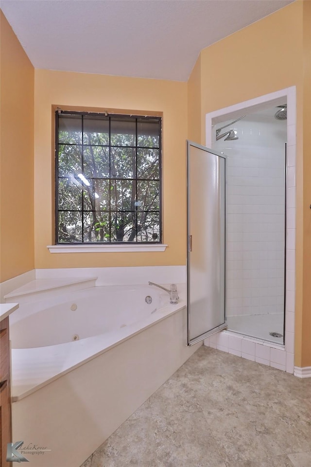 bathroom featuring vanity and plus walk in shower