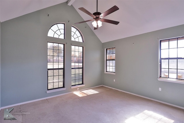 empty room featuring beamed ceiling, ceiling fan, high vaulted ceiling, and light carpet