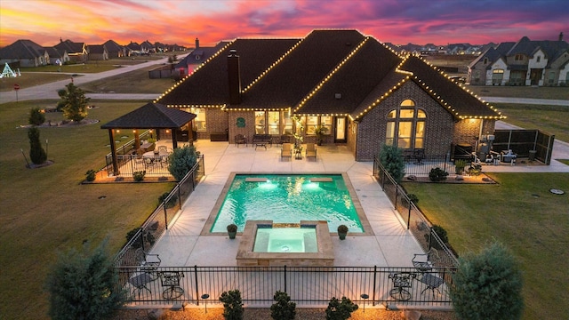 pool at dusk with a fenced backyard, a residential view, a patio, and a gazebo