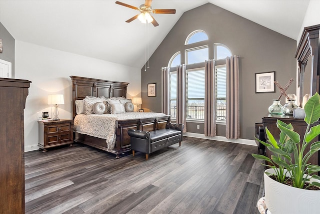 bedroom featuring dark wood-type flooring, multiple windows, high vaulted ceiling, and baseboards