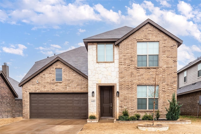 traditional-style home featuring driveway, stone siding, a garage, and brick siding