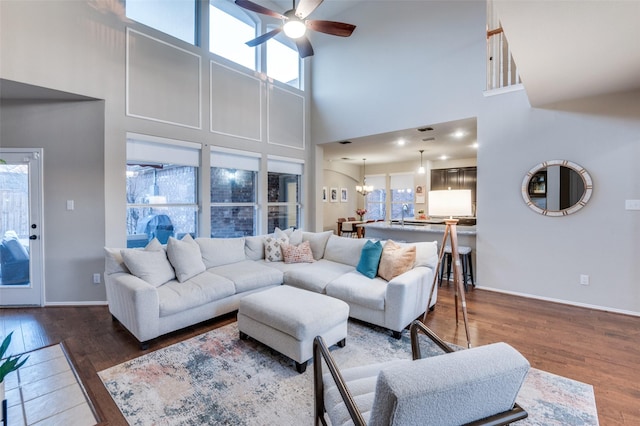 living room featuring sink, ceiling fan with notable chandelier, and dark hardwood / wood-style floors