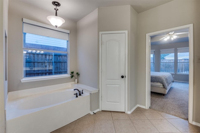 bathroom featuring tile patterned flooring and a bath