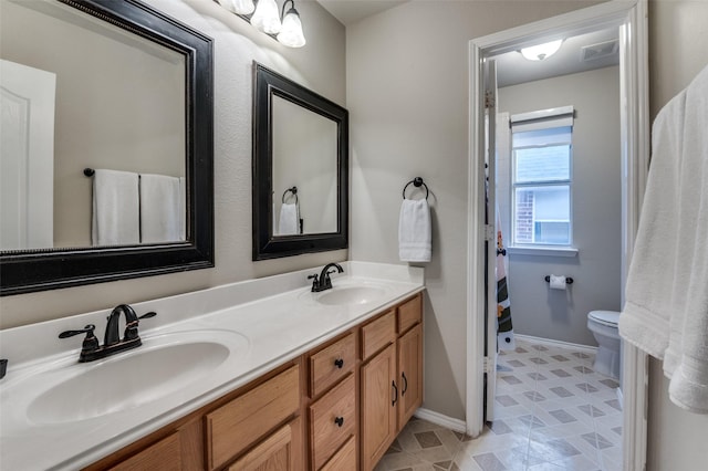 bathroom with vanity and toilet