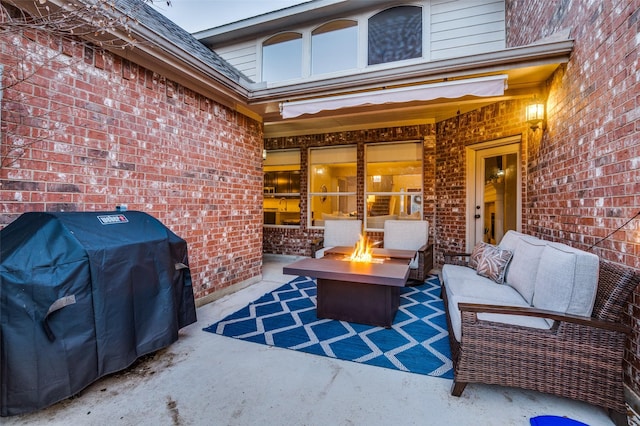 view of patio with an outdoor fire pit and a grill