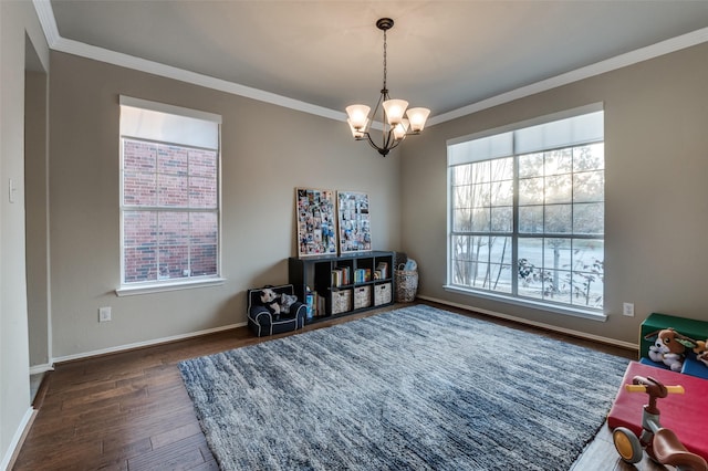 misc room with ornamental molding, dark hardwood / wood-style floors, and a chandelier