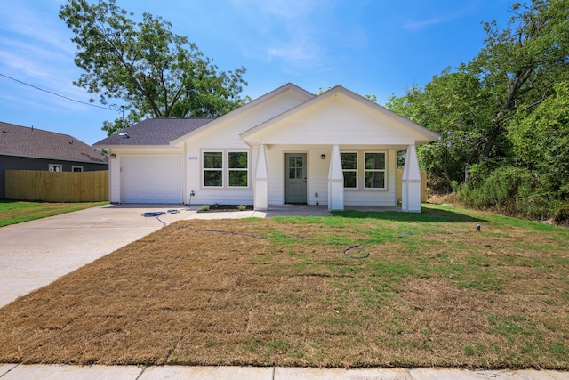 view of front of house with a garage and a front yard