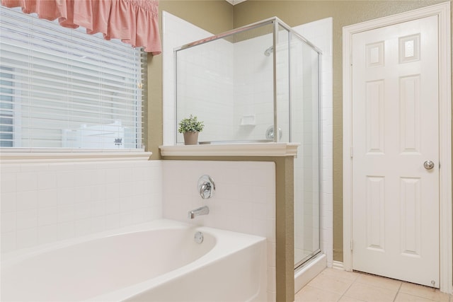 bathroom with tile patterned flooring and independent shower and bath