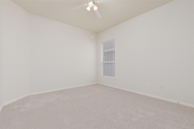 empty room featuring ceiling fan and carpet