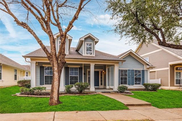 view of front of property with a porch and a front lawn