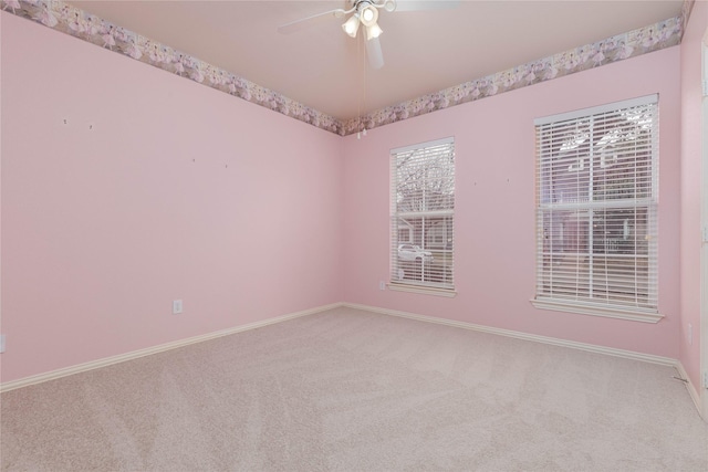 carpeted empty room featuring ceiling fan